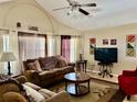 Inviting living room featuring cozy seating, a ceiling fan, and natural light from the window at 2734 Rio Grande Trl # 2734, Kissimmee, FL 34741