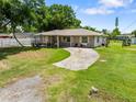 Spacious front yard with a concrete driveway leading to a charming, single-story home at 2947 Larson St, Kissimmee, FL 34741