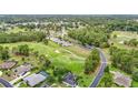 Aerial view showcasing property nestled on golf course amidst lush greenery and community at 30 Lake Diamond Ave, Ocala, FL 34472