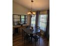Charming dining area with modern lighting fixture, a wooden buffet and seating for four at 30 Lake Diamond Ave, Ocala, FL 34472
