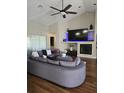 Cozy living room featuring a modern fireplace, vaulted ceiling, and ample natural light at 30 Lake Diamond Ave, Ocala, FL 34472