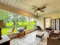 Enclosed sunroom with views of the green space and tiled flooring, perfect for relaxation at 30 Lake Diamond Ave, Ocala, FL 34472