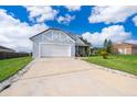 Charming one-story home with a two-car garage, beautifully landscaped front yard, and a well-maintained driveway at 3647 Minute Maid Ramp Rd 1 Rd, Davenport, FL 33837