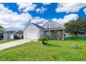 Picture of a lovely home featuring a well-kept lawn, charming landscaping, and a welcoming entryway at 3647 Minute Maid Ramp Rd 1 Rd, Davenport, FL 33837