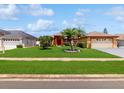 Landscaped single Gathering home with lush green lawn and mature trees in a residential neighborhood at 3811 Gator Bay Ln, St Cloud, FL 34772