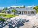 Inviting single Gathering home with long driveway, lush green lawn, and charming curb appeal on a sunny day at 435 Pennsylvania Ave, St Cloud, FL 34769