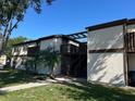 Two-story building with stucco exterior, dark wood accents and second-story landings at 4905 Sanoma Vlg # Ge, Orlando, FL 32808