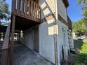 Exterior view of building with stucco and wood exterior and second story landing at 4905 Sanoma Vlg # Ge, Orlando, FL 32808