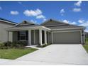 Inviting single-story house with a spacious driveway, attached garage, and meticulously landscaped front yard at 537 S Andrea Cir, Haines City, FL 33844