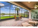 Relaxing screened patio with comfortable seating and tranquil lake views for outdoor enjoyment at 561 Tapatio Ln, Kissimmee, FL 34759