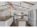 Bright kitchen with white cabinetry, granite countertops, stainless steel appliances, and an island at 710 Carlton Ave, Lake Wales, FL 33853