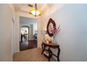 Bright hallway features tile flooring, a decorative mirror, and a glimpse into the living spaces at 8835 Abbey Leaf Ln, Orlando, FL 32827