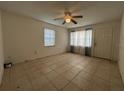 Bright living room featuring tiled floors, a ceiling fan, and a window with blinds at 127 Alabama Ave, St Cloud, FL 34769
