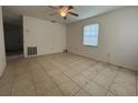Living room with tiled floors, a ceiling fan, and natural light from a window at 127 Alabama Ave, St Cloud, FL 34769