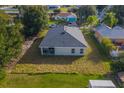 Aerial view showcasing a spacious backyard and a covered porch area at 130 Mediterranean Ct, Kissimmee, FL 34758