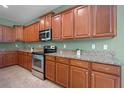 Gourmet kitchen with stainless steel appliances and lots of wood cabinets at 1394 Palmetto Dunes St, Champions Gate, FL 33896