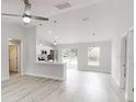 Bright open-concept living area with modern flooring and a view into the kitchen at 14512 Sw 25Th Lane, Ocala, FL 34481