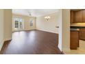 Spacious living room with hardwood floors, ceiling fan, and French doors at 1501 Northern Harrier Way # 202, Reunion, FL 34747