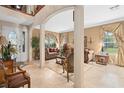 Open-concept living room with a decorative entry door, plush sofas, and neutral finishes at 15037 Cedar Branch Way, Orlando, FL 32824