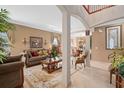Elegant living room with neutral walls, plush furnishings, and decorative details at 15037 Cedar Branch Way, Orlando, FL 32824