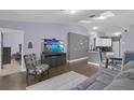 Open-concept living room with hardwood floors and plenty of natural light at 1651 Windsor Oak Ct, Kissimmee, FL 34744