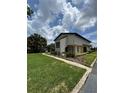 Well-maintained home exterior with lush green lawn and manicured landscaping at 1844 Townhall Ln # 1844, Orlando, FL 32807