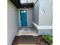 View of a charming front door with decorative glass and tile entryway at 198 N Lake Ct, Kissimmee, FL 34743