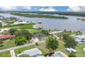 Breathtaking aerial view of waterfront home with lush greenery and stunning views of the serene bay at 203 Parkwood Ln, Edgewater, FL 32132