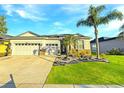 Charming single-Gathering home with lush lawn, palm trees, and a convenient two-car garage at 2164 Crosston Cir, Orlando, FL 32824