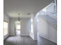 Living room with wood floors, lots of natural light, and a staircase to the second floor at 257 Lancaster Dr, Davenport, FL 33897