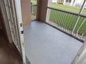 Enclosed balcony offering outdoor space with open views of the grassy area at 3001 Greystone Loop # 106, Kissimmee, FL 34741