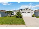 Charming single-story home with well-manicured lawn and two-car garage at 3211 Sweet Acres Pl, St Cloud, FL 34772