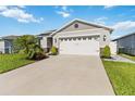 Charming single-story home with well-manicured lawn and two-car garage at 3211 Sweet Acres Pl, St Cloud, FL 34772