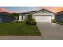 Charming single-story home with well-manicured lawn and two-car garage at 3211 Sweet Acres Pl, St Cloud, FL 34772
