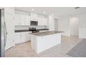 Bright kitchen with white cabinetry, stainless steel appliances, and a granite-topped island at 3214 Viceroy Ct, Kissimmee, FL 34759