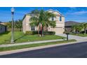 Two-story home with a well-manicured lawn, lush landscaping, and a two-car garage at 3391 Cortland Dr, Davenport, FL 33837