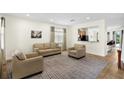Cozy living room includes comfortable seating and a view of the adjacent kitchen at 341 Lasso Dr, Kissimmee, FL 34747