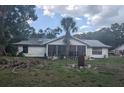 Rear view of the home with a large, screened-in patio at 4345 Old Colony Rd, Mulberry, FL 33860