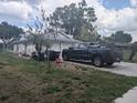 Side of the home with a two-car garage and a truck parked in the driveway at 4345 Old Colony Rd, Mulberry, FL 33860