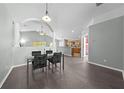 An open-concept dining area showcases a modern glass table, tile floors, and elegant architectural details at 4726 Ashurst St, Kissimmee, FL 34758