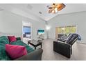 Inviting living room with access to the backyard, a comfortable sofa, and sleek black furniture at 4726 Ashurst St, Kissimmee, FL 34758