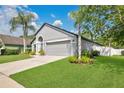 Lovely home with a well-maintained lawn, mature trees, and a convenient two-car garage at 501 Dunoon St, Ocoee, FL 34761