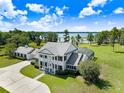 Estate with a screened pool, mature trees, and an elegant two-story house at 5150 Gentry Oaks Pl, St Cloud, FL 34772