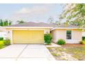Charming one-story home featuring an attached two-car garage and a well-maintained, landscaped front yard at 56 Levee Ln, Ormond Beach, FL 32174