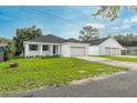 Charming home exterior with a lush lawn and a convenient three-car garage for all your vehicles at 6479 Apple St, St Cloud, FL 34771