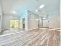 Open-concept living room featuring high ceilings, modern fans, and sliding glass doors at 713 Wood Ln, Kissimmee, FL 34759