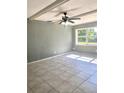 Bright living room featuring tile floors, a ceiling fan, and a large window at 721 S Clyde S Ave, Kissimmee, FL 34741