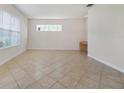 Spacious living room with tile flooring, bright natural light, and a built-in desk at 7740 Linkside Loop, Reunion, FL 34747