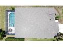 Aerial view of home showing roof, screened-in pool, and surrounding yard at 805 Suffolk Pl, Davenport, FL 33896