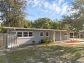 Charming single story home with welcoming front porch and a well-maintained yard under a clear sky at 807 E Airport Blvd, Sanford, FL 32773